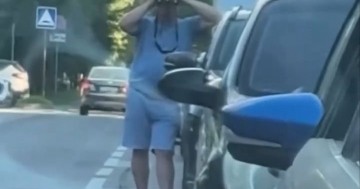 Russian man tries to make out start of queue at petrol station through his binoculars